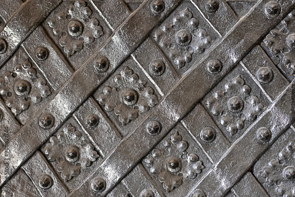 Black forged door, rhombus symmetrical texture. Black forged door, rhombus symmetrical texture.