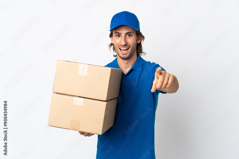 Delivery man isolated on white background surprised and pointing front Delivery man isolated on white background surprised and pointing front