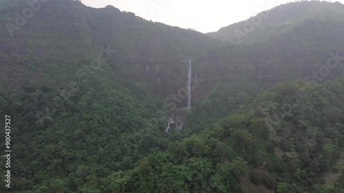 Beautiful waterfall in green forest in jungle at sunrise at Cikanteh Waterfall Geopark CIiletuh, Sukabumi, Indonesia. Nature background photo