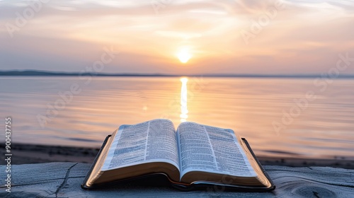 Open Bible by Serene Lakeside at Sunrise With Reflective Water