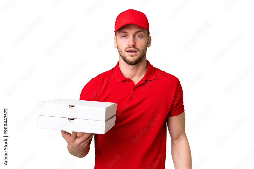 Pizza delivery man with work uniform picking up pizza boxes over isolated chroma key background with surprise facial expression Pizza delivery man with work uniform picking up pizza boxes over isolated chroma key background with surprise facial expression