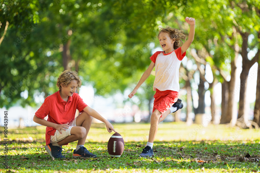 Family playing American football. Kids play rugby Family playing American football. Kids play rugby