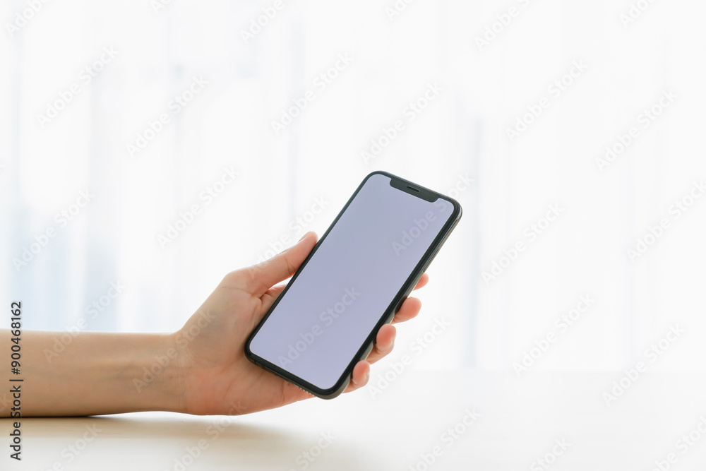 Hand holding smartphone mockup of blank screen for graphic display montage. Hand holding smartphone mockup of blank screen for graphic display montage.