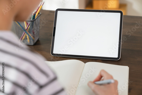 Mock up of woman hand holding digital tablet and touching blank screen.
