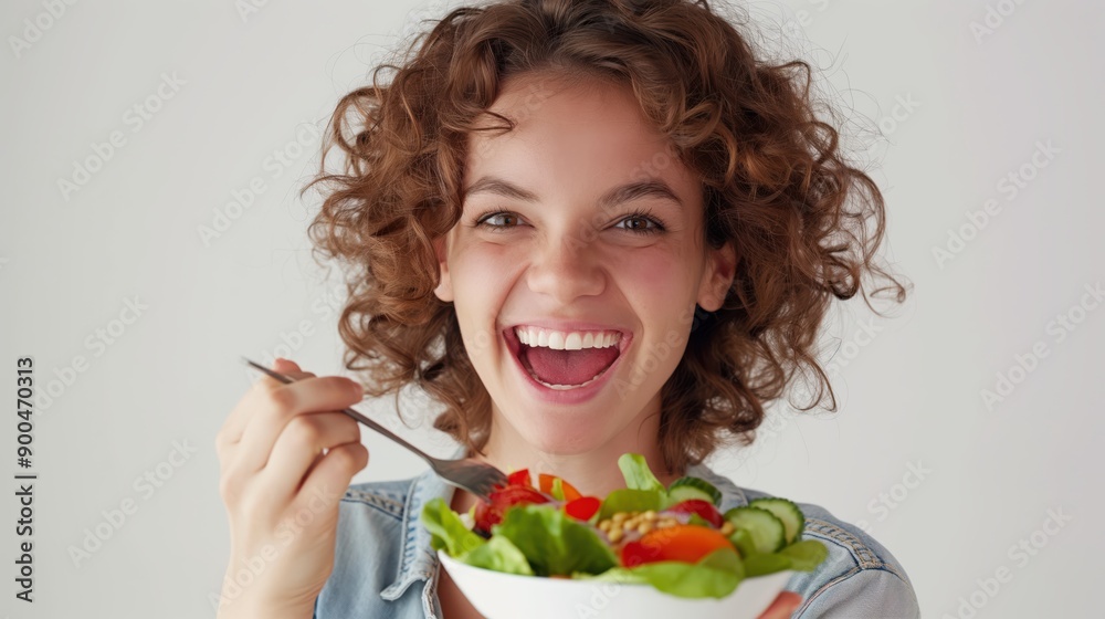 Happy woman enjoying nutritious salad against a clean white background Happy woman enjoying nutritious salad against a clean white background