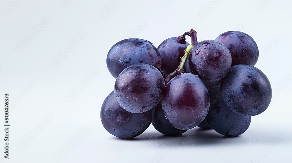 A cluster of ripe Concord grapes with water drops on a white background. A cluster of ripe Concord grapes with water drops on a white background.
