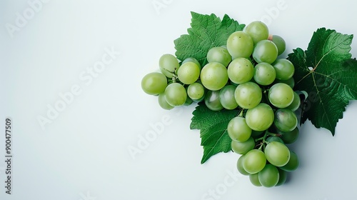 A close-up image of a bunch of green grapes with leaves on a white background. The grapes are plump and juicy, and the leaves are a deep green color. photo