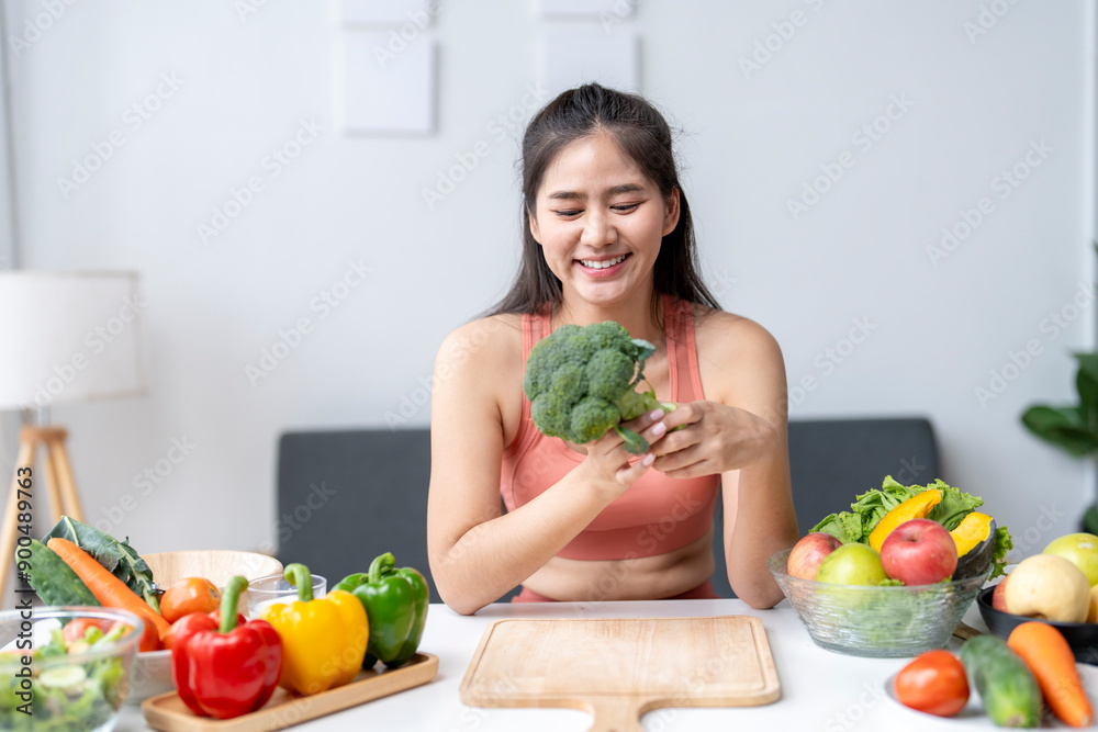 Smiling young woman is preparing a vegan meal with fresh vegetables Smiling young woman is preparing a vegan meal with fresh vegetables