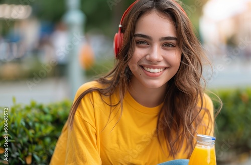 Smiling Woman With Headphones and Juice