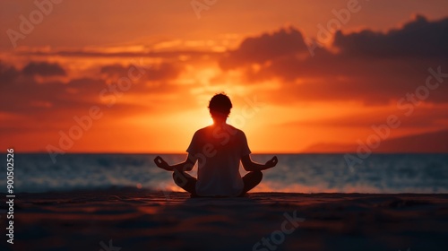 Silhouetted Person Meditating at Sunset on a Beach