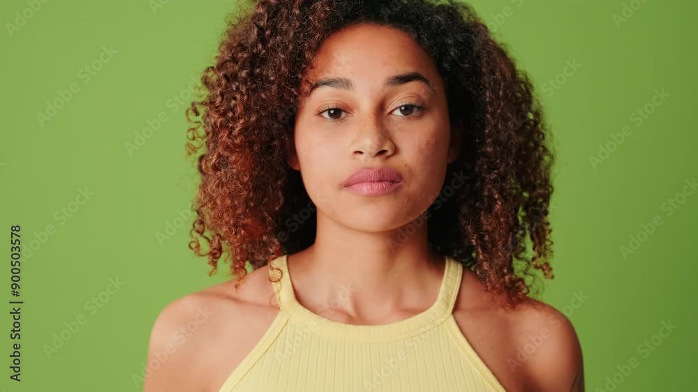 Calm young woman with eyes closed at green screen background Calm young woman with eyes closed at green screen background