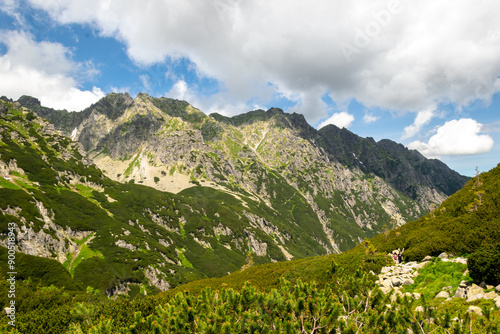 Fototapeta Naklejka Na Ścianę i Meble -  Mountains in Tatra National Park, Poland. In the distance, tourists on the trail.