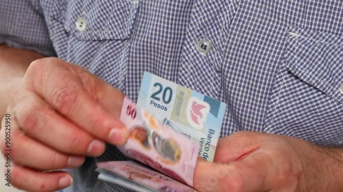 Mexico Money. Man counts Mexican pesos. Financial concept