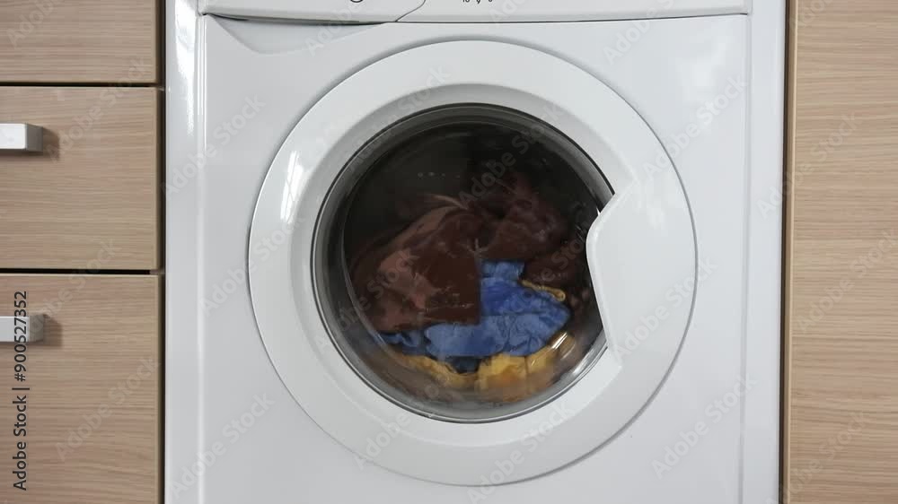 Close-up of a built-in washing machine in a home kitchen.
