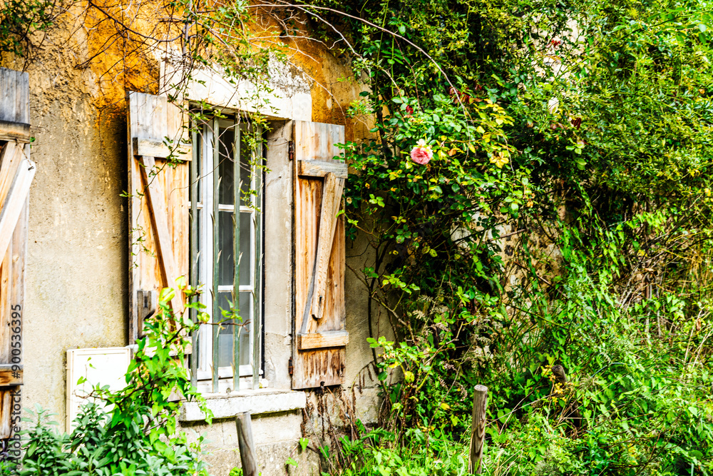 Flowered and picturesque facade of a house in Giverny's where French painter Claude Monet lived, Normandy region, France. Flowered and picturesque facade of a house in Giverny's where French painter Claude Monet lived, Normandy region, France.