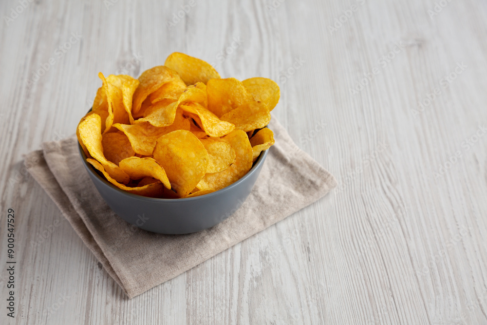 Bacon Flavored Potato Chips in a Bowl, side view. Copy space. Bacon Flavored Potato Chips in a Bowl, side view. Copy space.