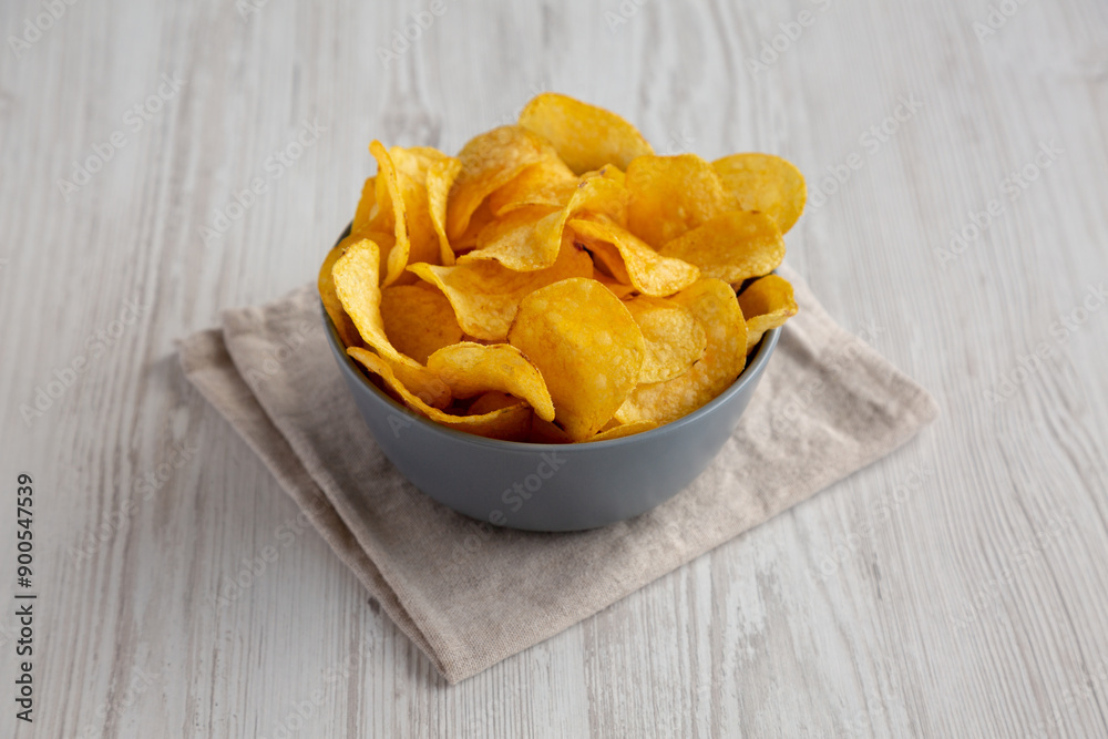 Bacon Flavored Potato Chips in a Bowl, side view. Bacon Flavored Potato Chips in a Bowl, side view.