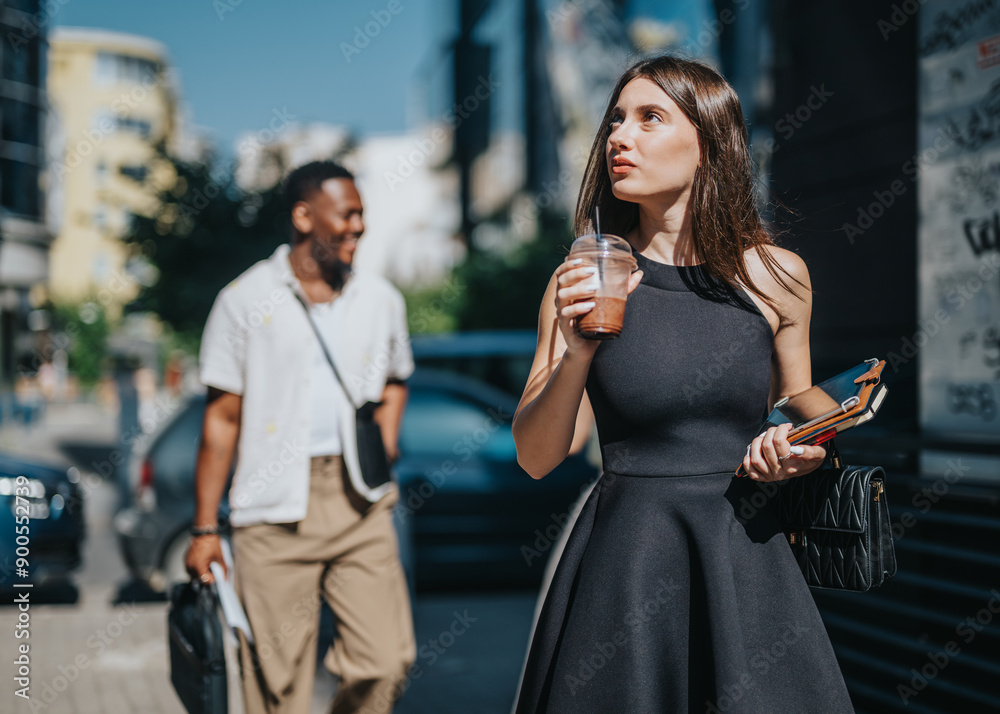 Two multicultural businesspeople meeting outdoors in the city. A mixed race group of professionals discussing business in an urban outdoor setting. Two multicultural businesspeople meeting outdoors in the city. A mixed race group of professionals discussing business in an urban outdoor setting.