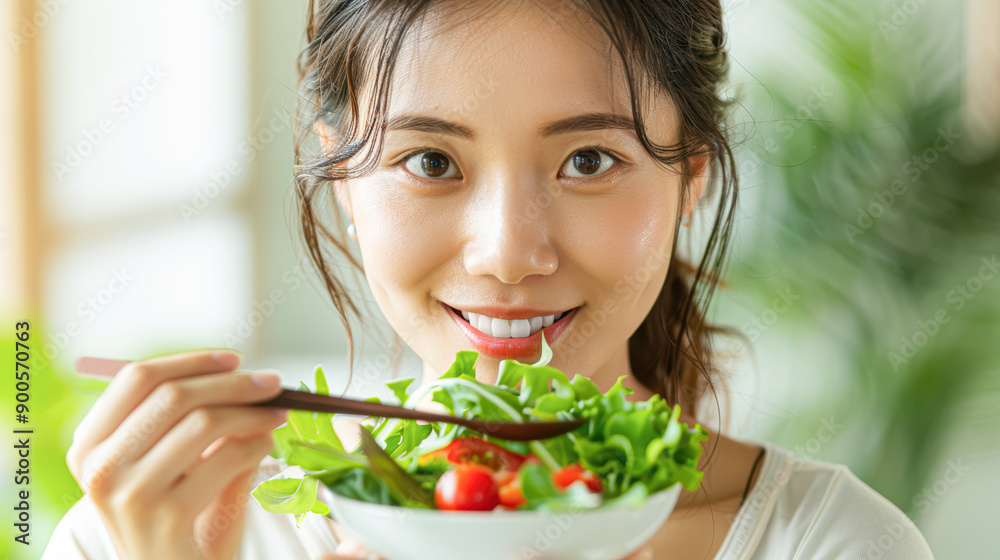 Asian person enjoying a healthy lunch, representing diet control and wellness Asian person enjoying a healthy lunch, representing diet control and wellness