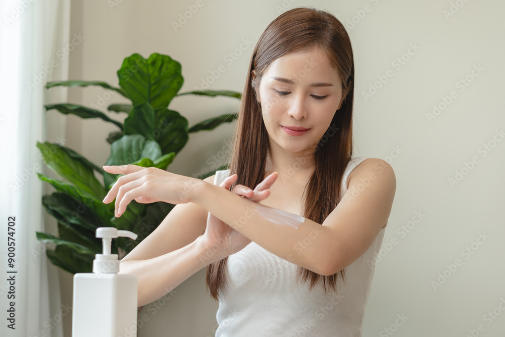 Health skin care, beauty smile asian young woman, girl hand applying, putting moisturizer on her arm, shoulder after shower bath at home. Skin body cream moisturizing lotion, routine in the morning. Health skin care, beauty smile asian young woman, girl hand applying, putting moisturizer on her arm, shoulder after shower bath at home. Skin body cream moisturizing lotion, routine in the morning.