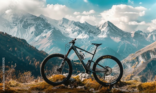 A mountain bike is parked against a stunning backdrop of snowy mountain peaks, representing the adventure and freedom associated with mountain biking in beautiful terrains photo