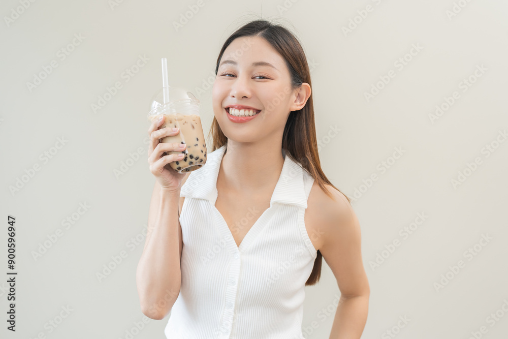 Beverage and food concept, Happy asian young woman hand holding plastic cup, glass of drink bubble, pearl milk tea with straw, cute girl drinking ice cold tea with tapioca boba ball popular in Taiwan. Beverage and food concept, Happy asian young woman hand holding plastic cup, glass of drink bubble, pearl milk tea with straw, cute girl drinking ice cold tea with tapioca boba ball popular in Taiwan.
