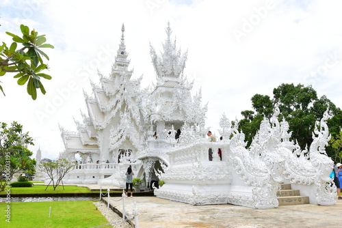 Chaing Rai, Thailand - July 27 ,2024 : White Temple (Wat Rong Khun) is one of the most famous attractions of Chiang Rai Province Northern Thailand. This was on a cloudy afternoon during wet season. 