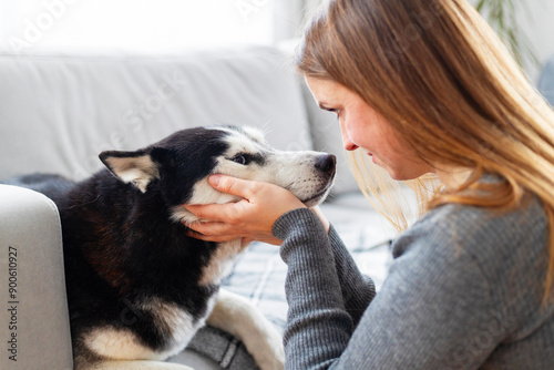 Woman bonding with her dog on the couch