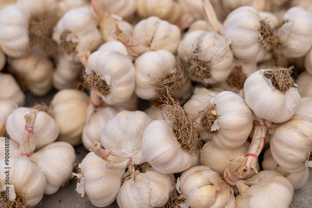 pile of fresh garlic on market, store or bazaar counter pile of fresh garlic on market, store or bazaar counter