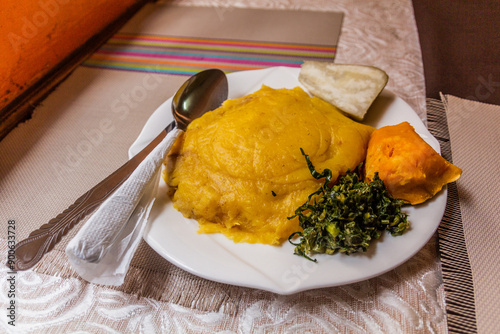 Lunch in Uganda - matoke (mashed plantains), tubers and sukuma photo