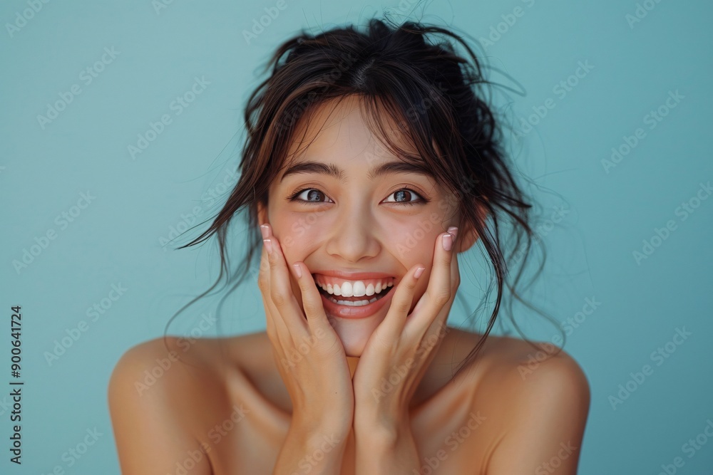 Joyful Asian Woman Laughing with Hands Covering Mouth on Plain Background Joyful Asian Woman Laughing with Hands Covering Mouth on Plain Background