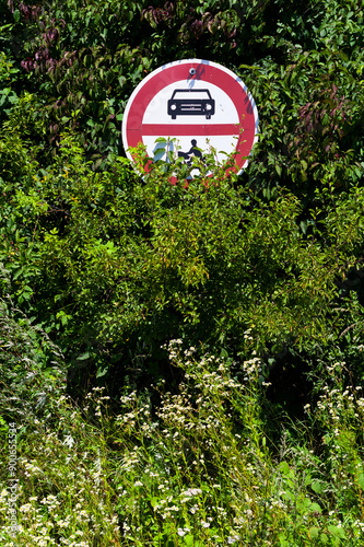 Badly placed traffic sign. The sign prohibits the entry of motor vehicles and pedestrians.