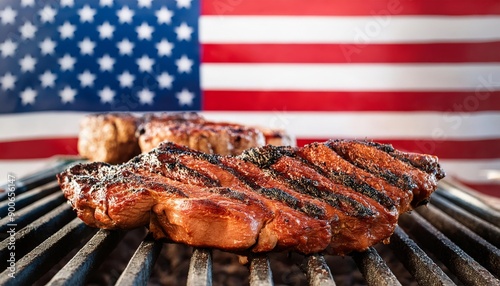 Delicious BBQ steaks grilling on a hot grill with an American flag in the background.