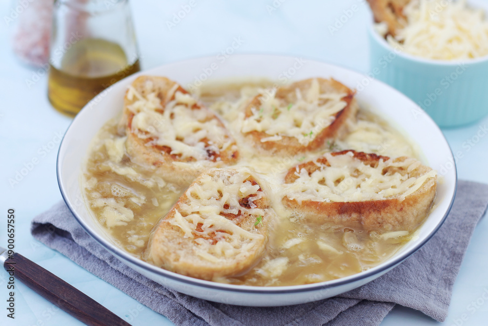 A ceramic bowl with French onion soup