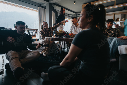 Group of friends gathered in a cozy home setting, enjoying each other's company with live guitar music and casual conversation.