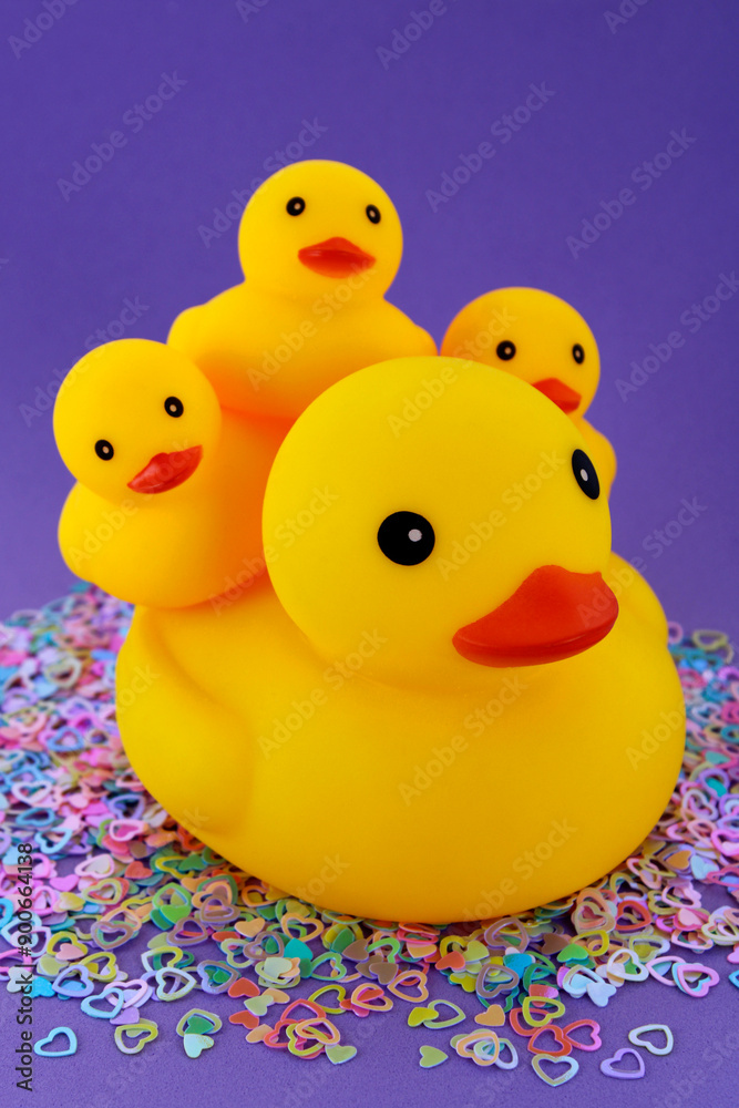 Mother duck giving love and protection to her three ducklings, plastic toy Mother duck giving love and protection to her three ducklings, plastic toy