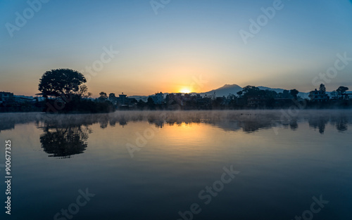 Gloomy Sunrise over the Taudah Lake in Kathmandu, Nepal photo