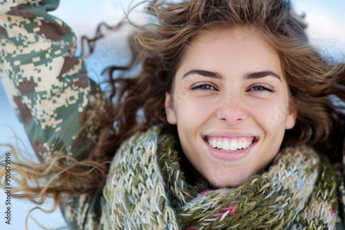 Smiling Woman in Winter Clothing Outdoors on a Bright Sunny Day photo