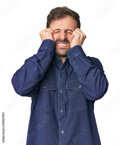 Studio portrait of young Hispanic male crying, unhappy with something, agony and confusion concept.