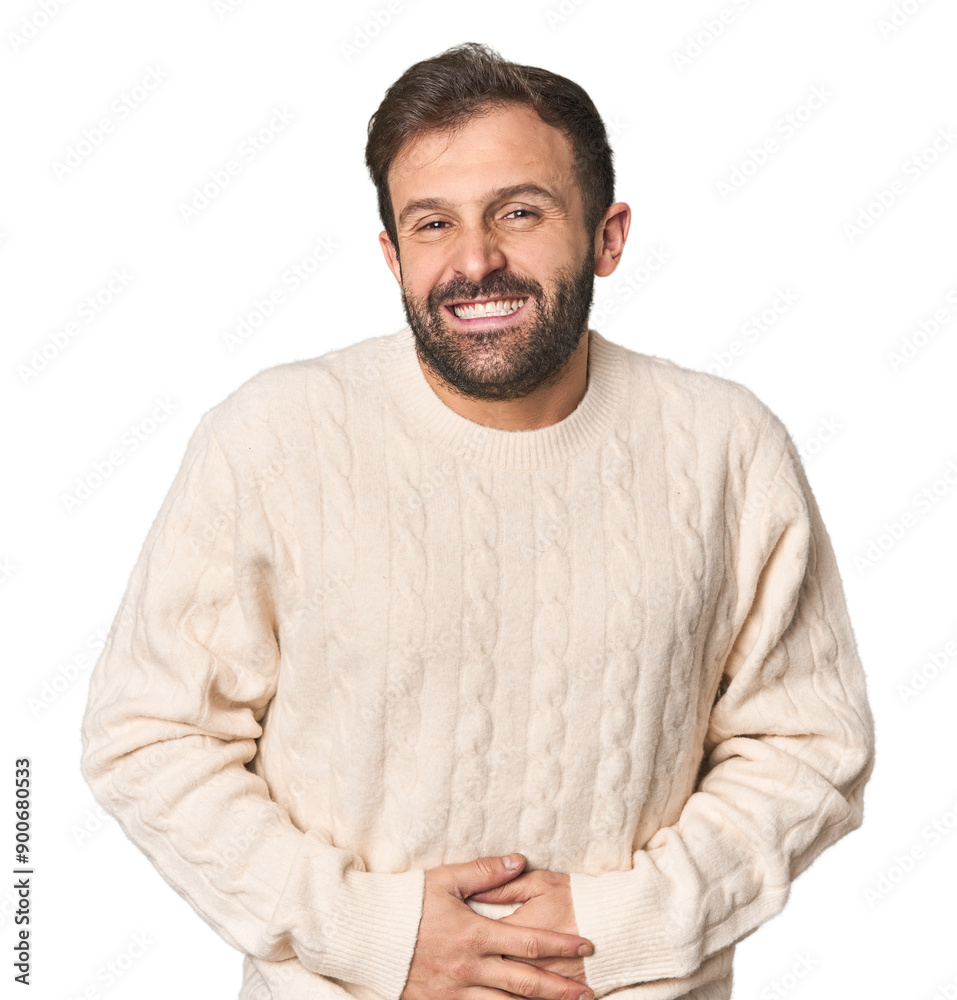 Fototapeta premium Studio portrait of young Hispanic male touches tummy, smiles gently, eating and satisfaction concept.