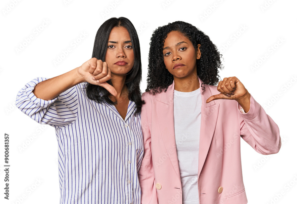 Young Latin businesswomen in studio showing a dislike gesture, thumbs down. Disagreement concept. Young Latin businesswomen in studio showing a dislike gesture, thumbs down. Disagreement concept.