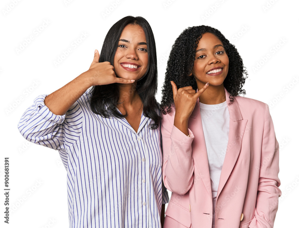 Young Latin businesswomen in studio showing a mobile phone call gesture with fingers. Young Latin businesswomen in studio showing a mobile phone call gesture with fingers.