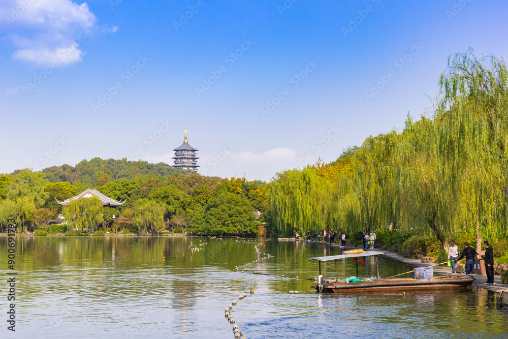 Wooden fishing boat in front of the Leiffeng Pagoda in Hangzhou, China