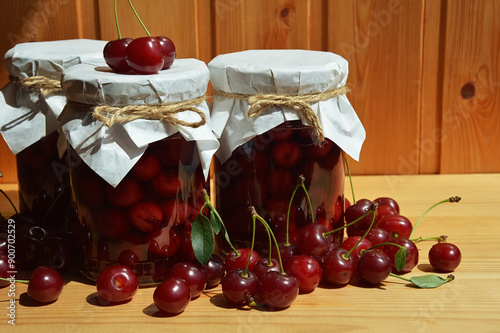cherry jam in glass jars, sweet confiture, homemade pastry preparations made from berries. ripe juicy berries. background for the design.