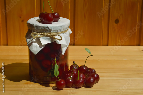 cherry jam in glass jars, sweet confiture, homemade pastry preparations made from berries. ripe juicy berries. background for the design. photo