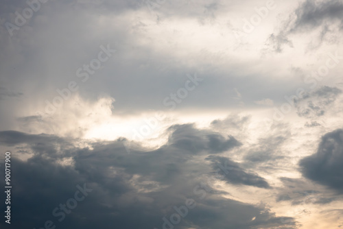 The sky is cloudy and grey. The clouds are low and dark. The sun is shining through the clouds