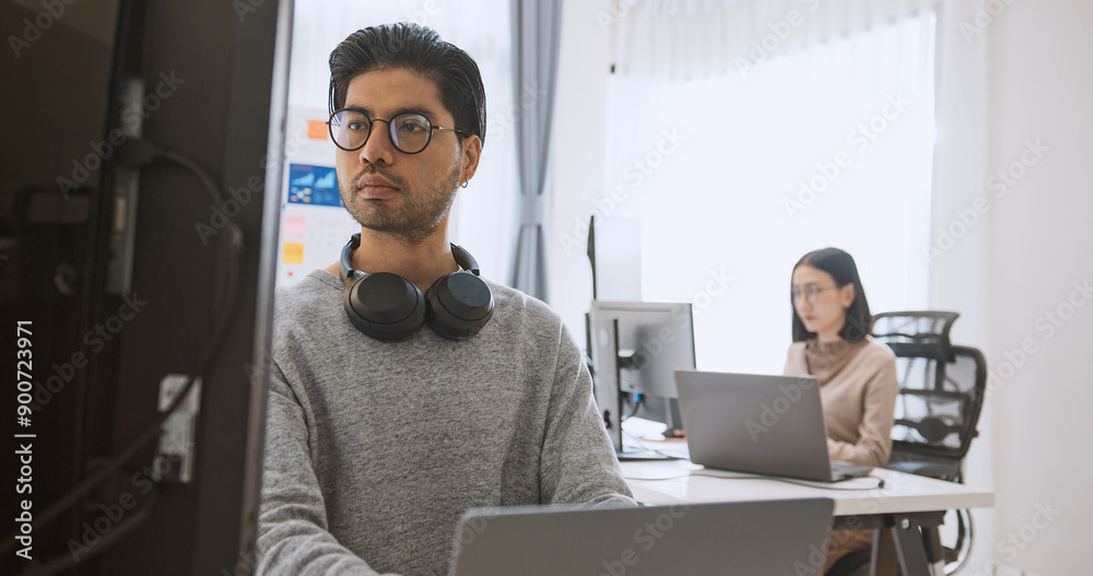 Young adult Asian male, female software developer coding program on desktop computer. Man, woman work from home, remote working, freelance programmer job, smart digital nomad lifestyle concept Young adult Asian male, female software developer coding program on desktop computer. Man, woman work from home, remote working, freelance programmer job, smart digital nomad lifestyle concept
