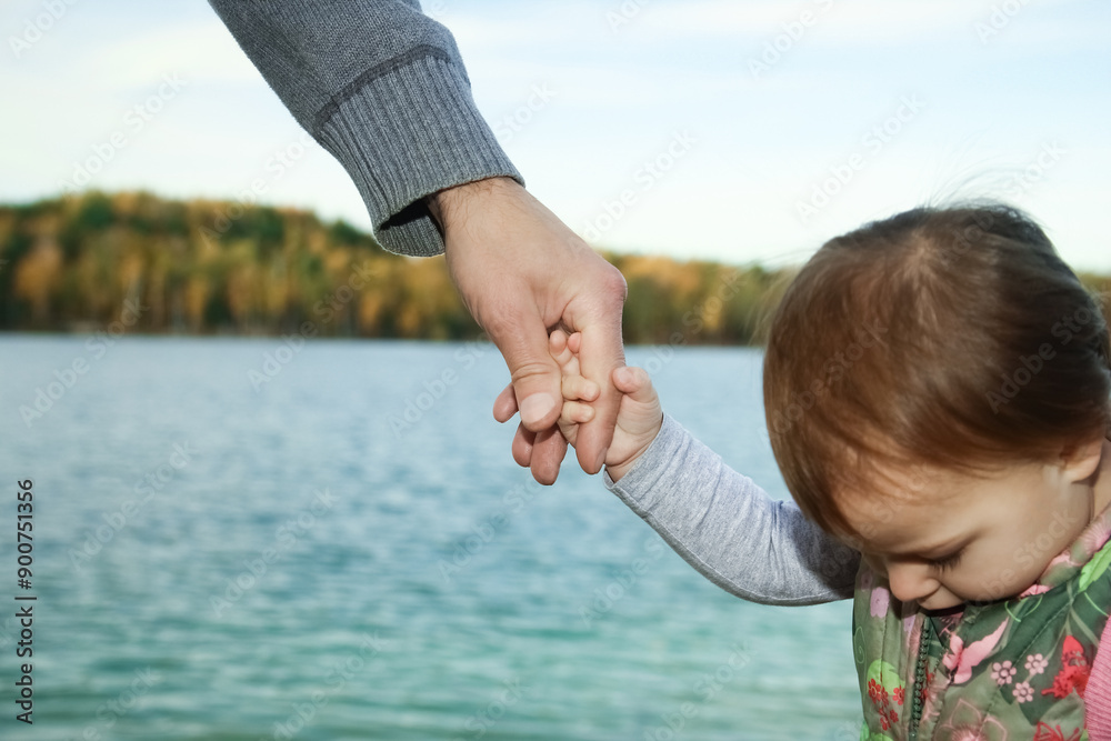 A beautiful hands of parent and child by the sea A beautiful hands of parent and child by the sea