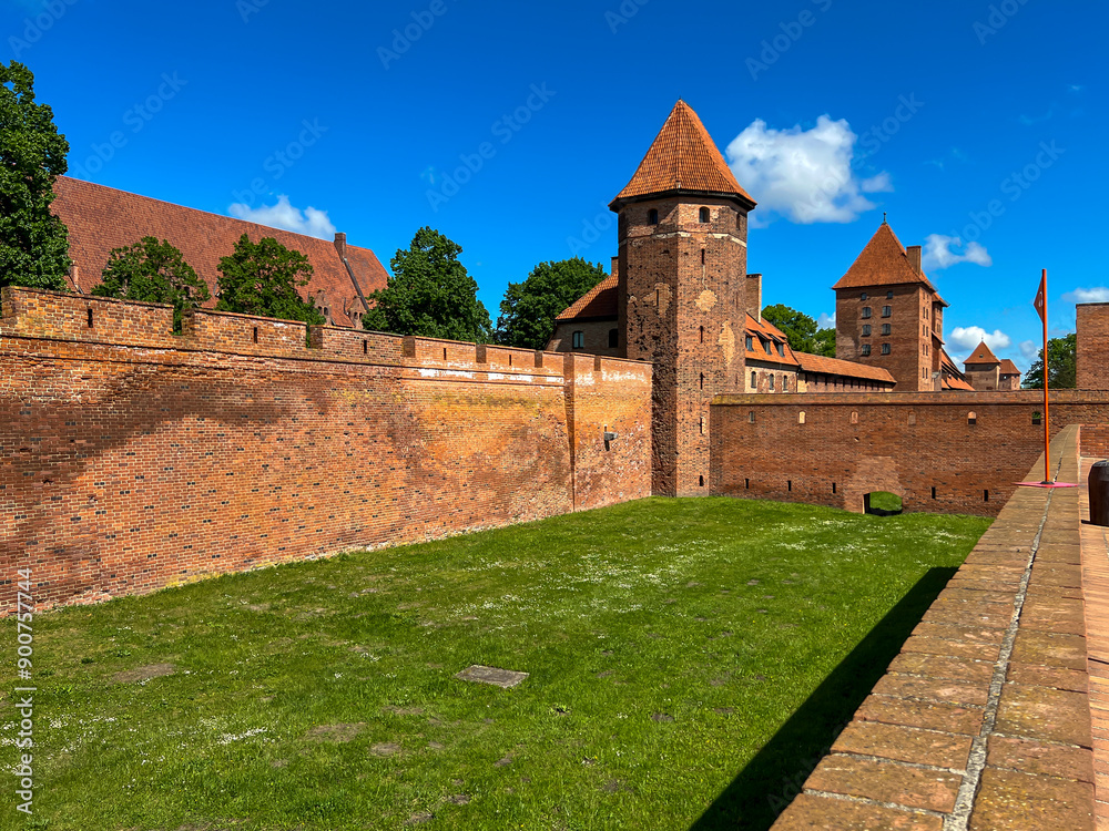 The Castle of the Teutonic Order in Malbork in Poland, commonly known as Malbork Castle The Castle of the Teutonic Order in Malbork in Poland, commonly known as Malbork Castle