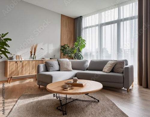 Interior of light living room with grey sofa wooden coffee table and big window